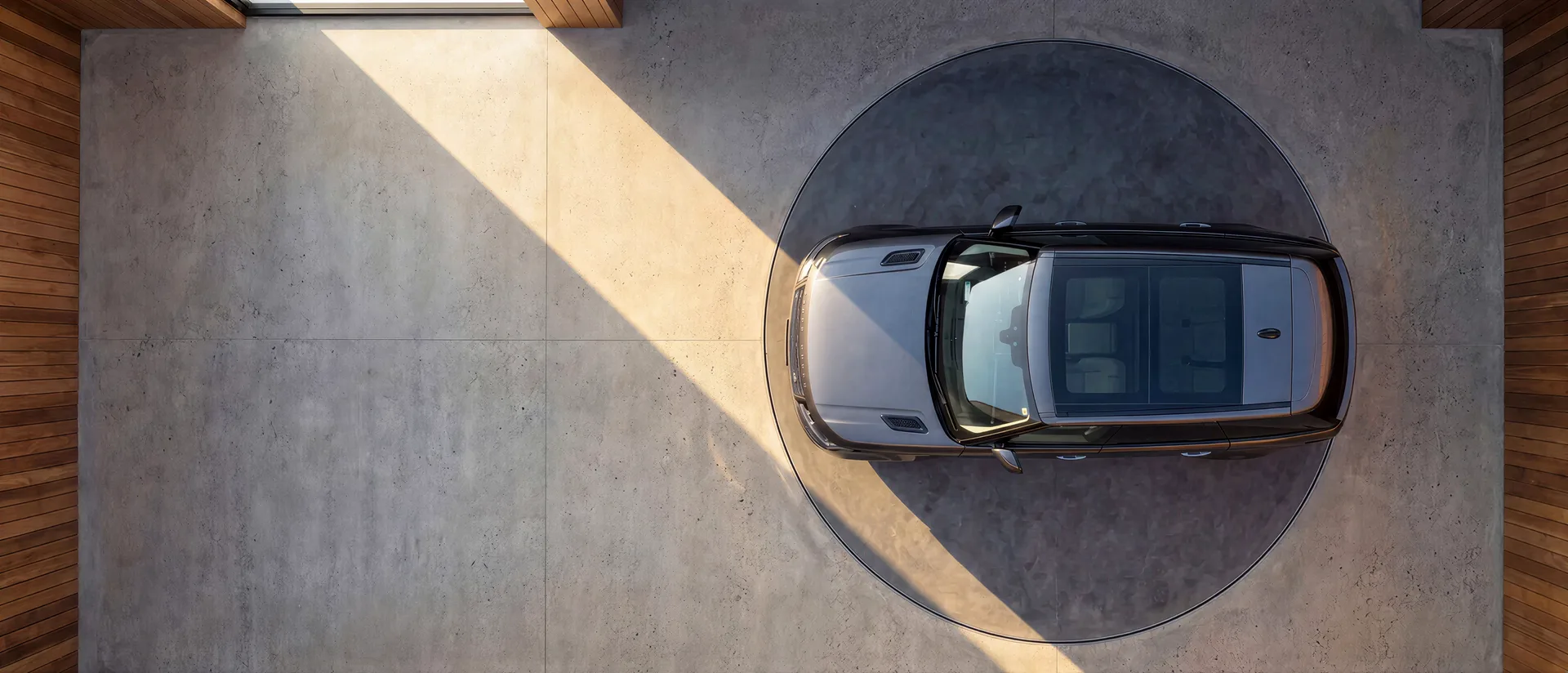 Overhead view of a car resting on a recessed vehicle turntable